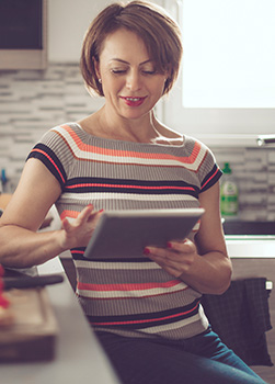 Woman using tablet in kitchen