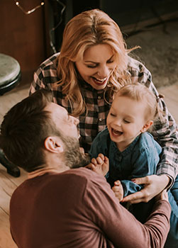 Young family playing in living room