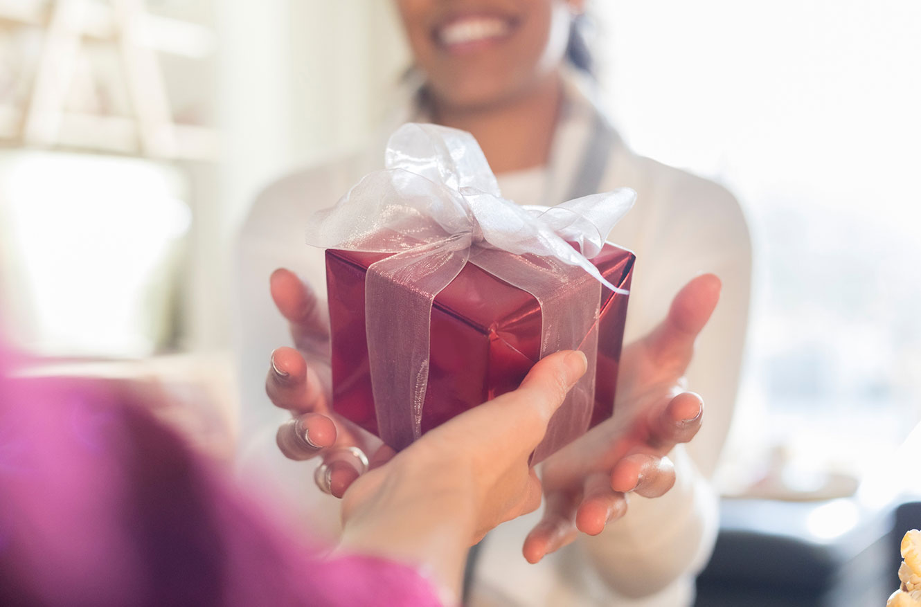Woman receiving a wrapped gift